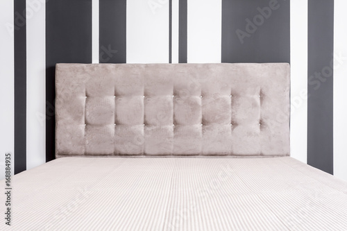 Bed with tufted headboard photo