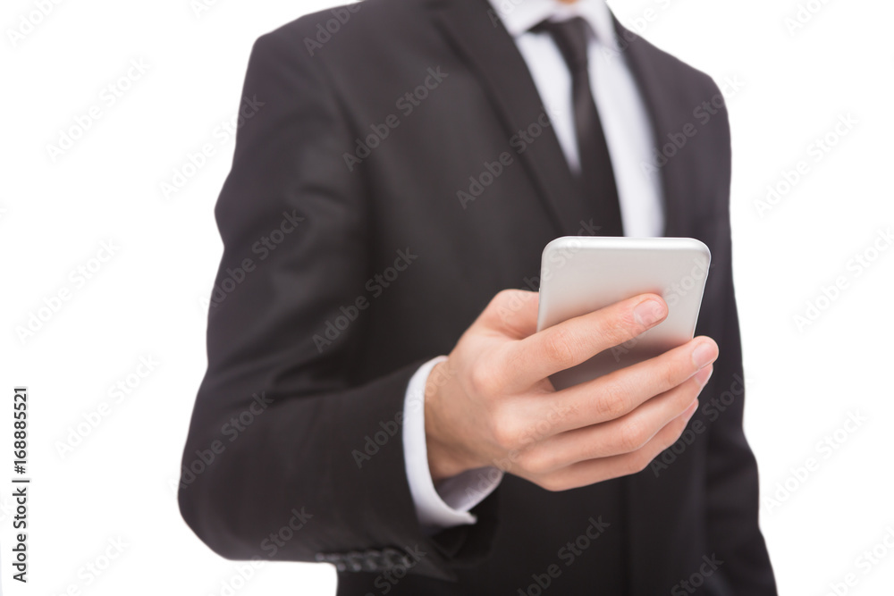 Unrecognizable businessman in suit with smartphone Unrecognizable businessman in suit with smartphone