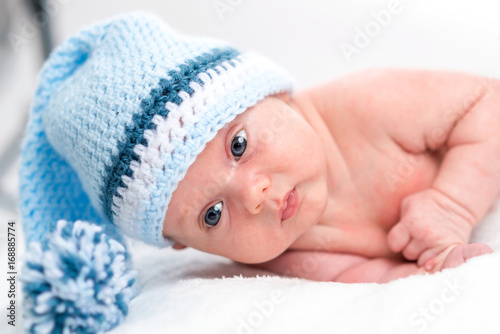 Newborn girl in blue cap 