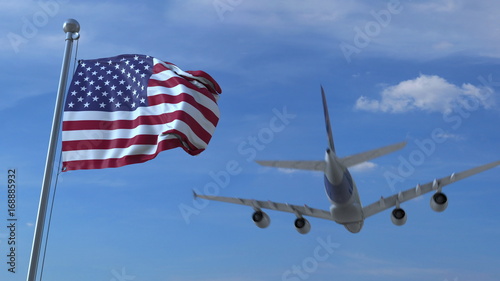 Commercial airplane landing behind waving American flag. Travel to the United States conceptual 3D rendering photo