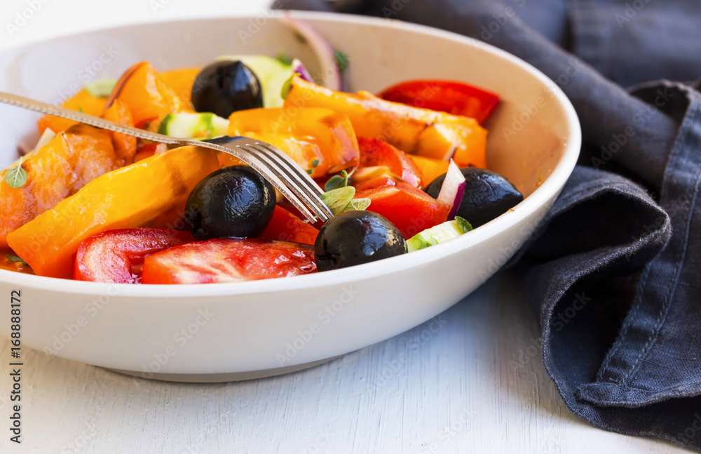 Vegetables salad closeup with tomatoes, olives,onion , cucumber and oregano spice