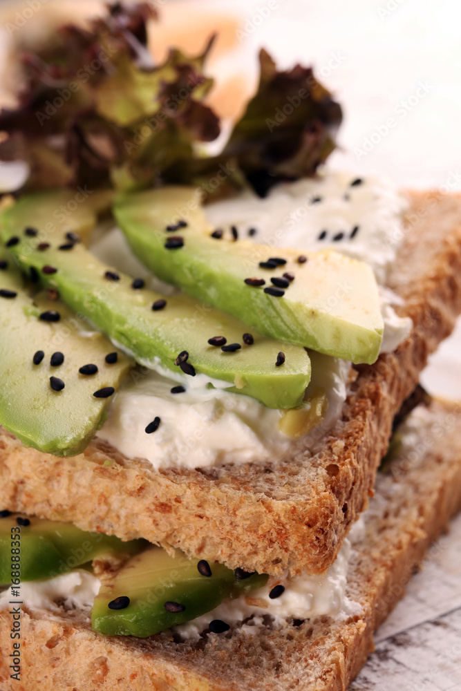 Sandwich with avocado and sesame - healthy breakfast concept