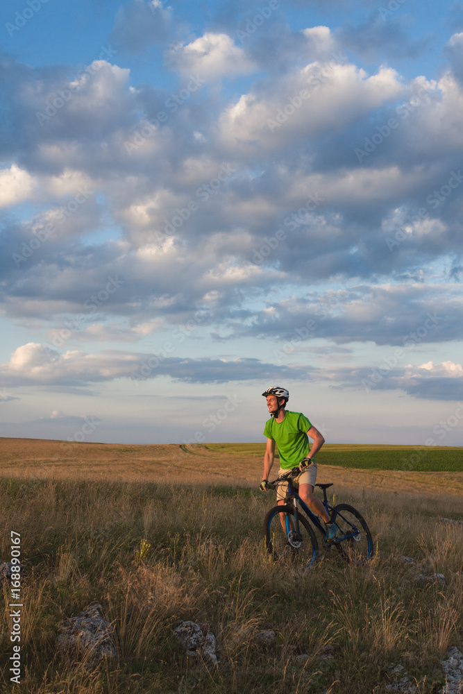 Young caucasian man with MTB admiring the natural landscape Young caucasian man with MTB admiring the natural landscape