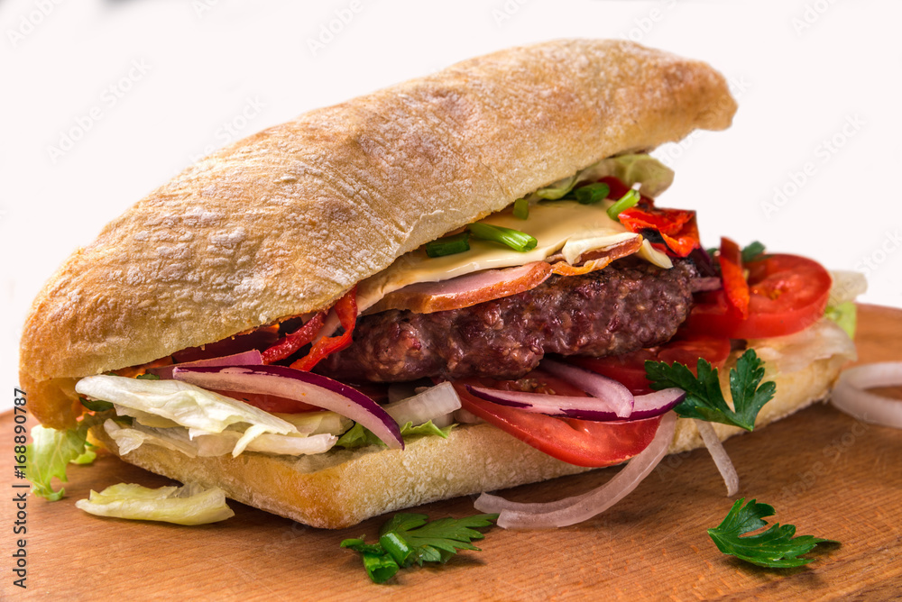 A sandwich with fried chops, herbs, tomatoes, peppers. Horizontal frame