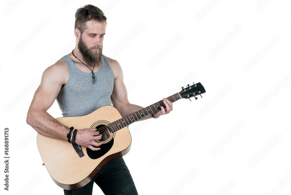 Obraz premium A charismatic man with a beard holds an acoustic guitar, on a white isolated background. Horizontal frame