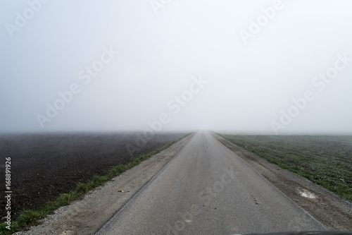 Fotografie, Obraz Road disappearing into fog.