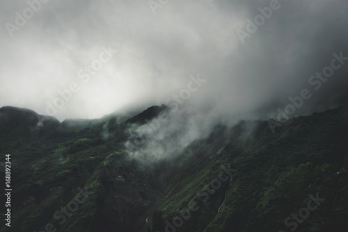 Dense grey fog and cloud on a high mountain summit