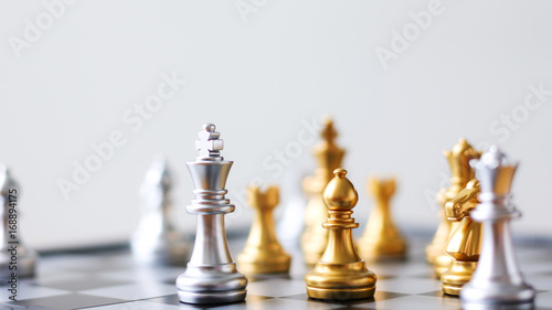 Close up shot golden and silver chess on black and white chess board game select focus shallow depth of field