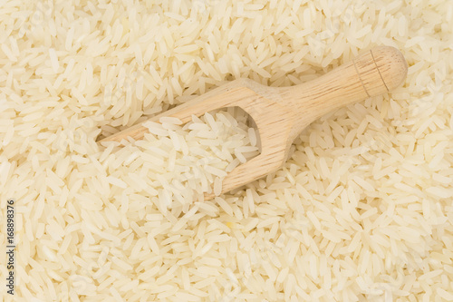 Rice in a wooden spoon on white background