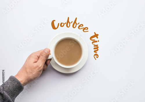 Coffee time text with male hand holding cup of coffee.business and drink concept