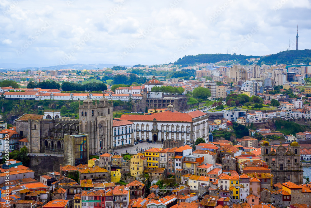 View over the old town of Porto, Portugal with the cathedral, the church of St. Lawrence, Ponte de Dom Luis I, Jardim do Morro and colorful buildings from Clerigos tower (Torre dos Clerigos)