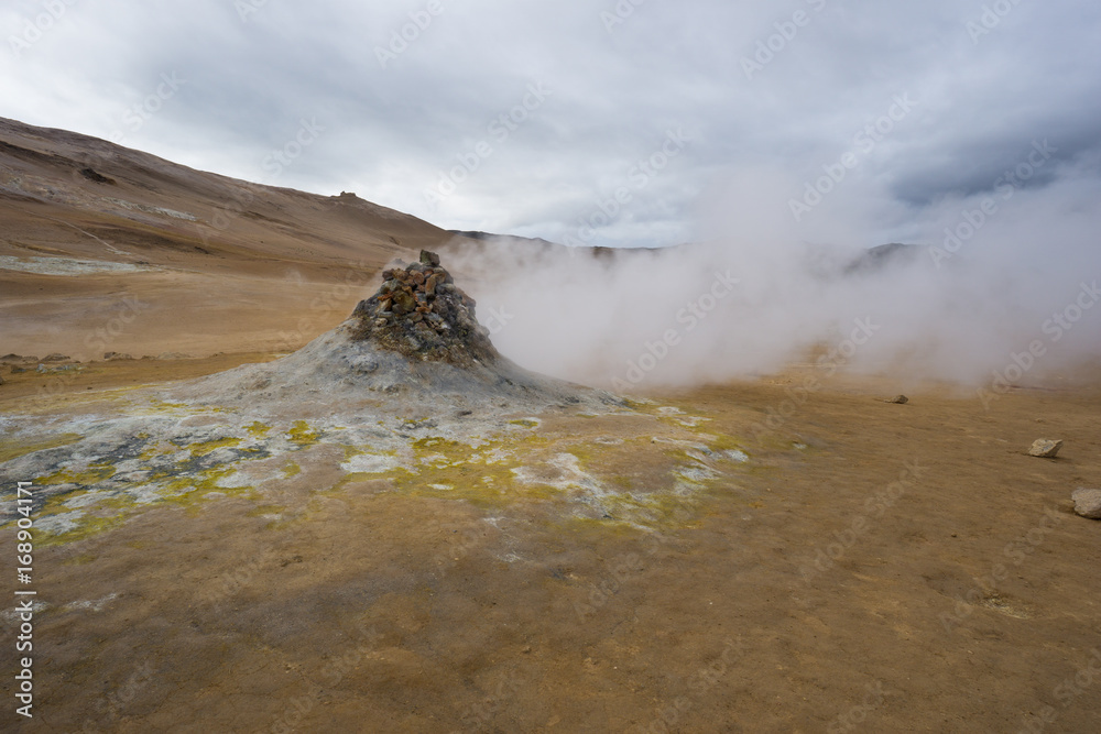 Iceland - Powerful fumarole pushing gas and hydrogen sulfide out of the yellow colored ground