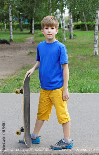 Handsome boy teenager with skateboard