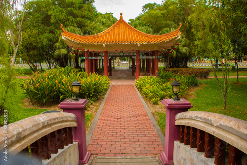 The bridge and the Chinese pavilion. Miri City Fan Park, Borneo, Sarawak, Malaysia photo