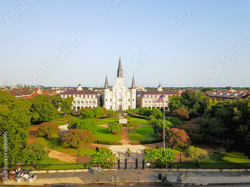 Aerial view of Jackson Square with Saint Louis Cathedral church in morning. A National Historic Landmark in New Orleans, Louisiana history. Horse and carriages wait to take people on city tours. photo