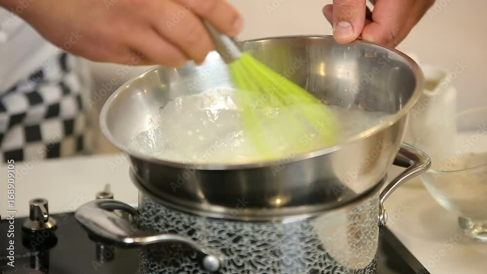 Whipping eggs in a water bath while cooking omelet Whipping eggs in a water bath while cooking omelet