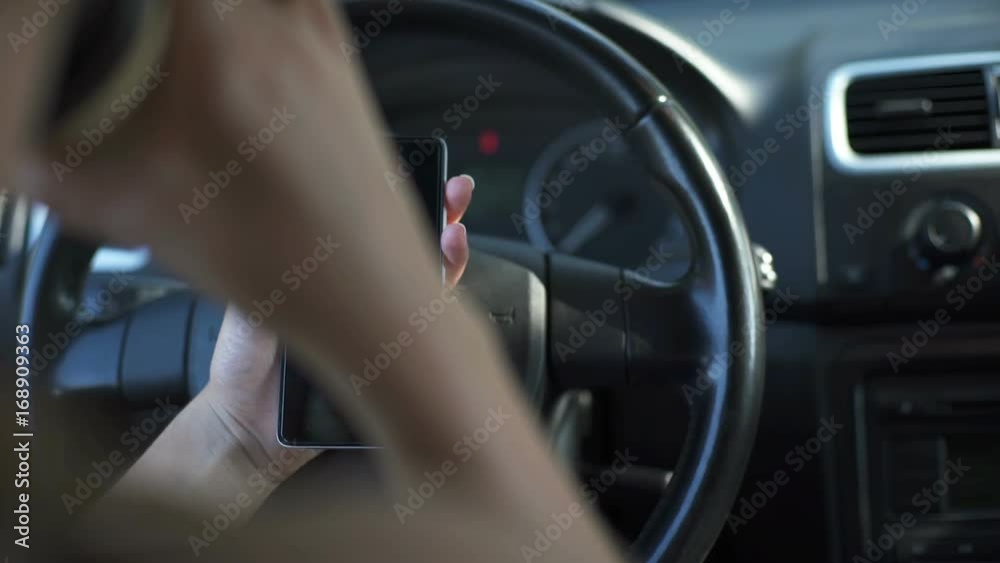 Woman sitting in the car using telephone and drinking coffee Woman sitting in the car using telephone and drinking coffee