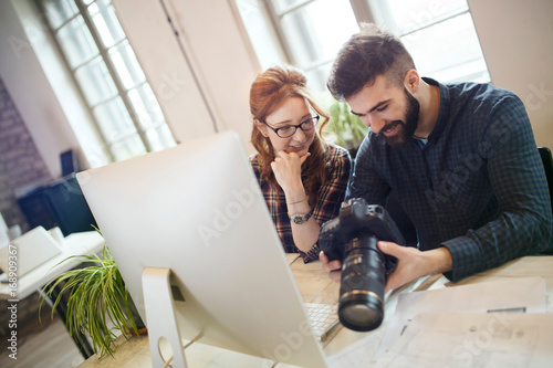 Picture of young attractive designers looking at camera photo