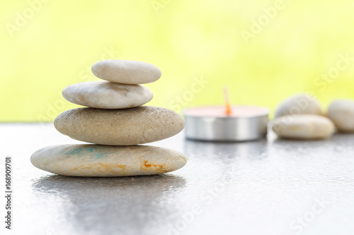 Stones pyramid symbolizing stability, zen ,Zen spa concept , Zen Massage Stone against green bokeh background