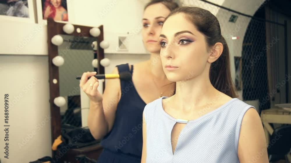 Young beautiful woman applying make-up by make-up artist Young beautiful woman applying make-up by make-up artist