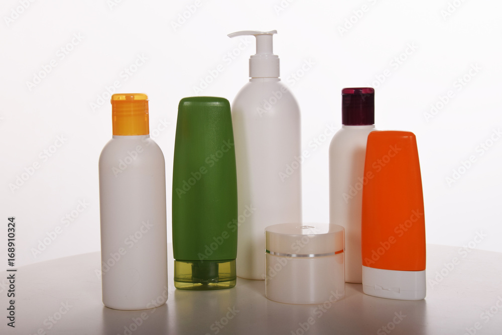 Cosmetics in bottles of plastic containers and tubes