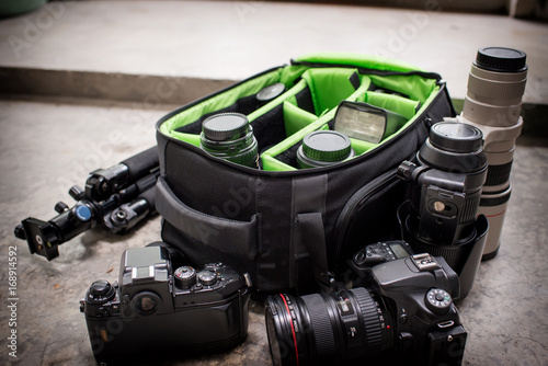 Photographer pack his camera and lenses to bagpack.