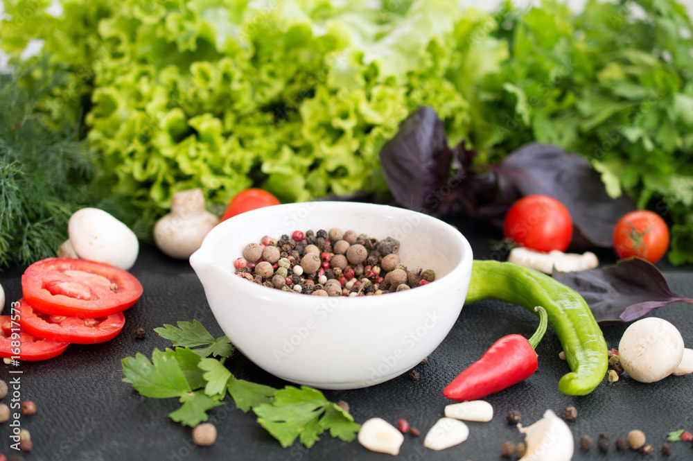 Fresh vegetables, greens and peppers peas in white bowl on dark background Fresh vegetables, greens and peppers peas in white bowl on dark background