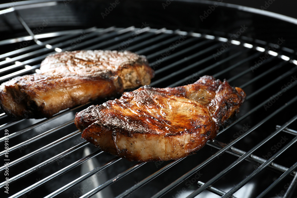 Tasty steaks on barbecue grill