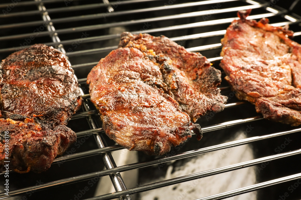 Tasty steaks on barbecue grill