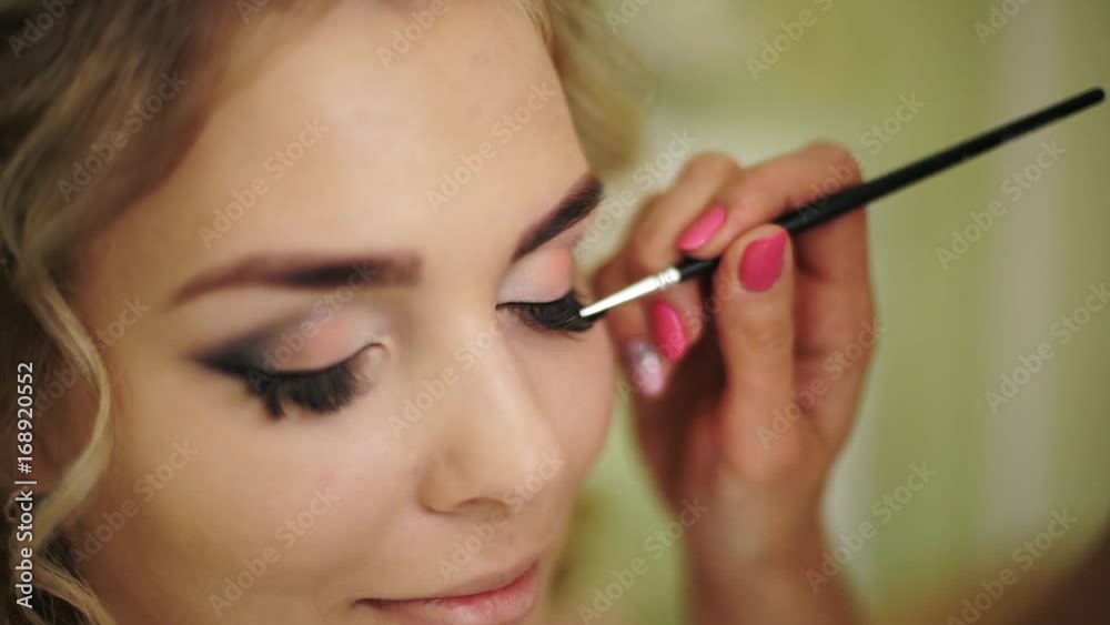 Weightlessness is painted with a brush of eyelashes. Professional makeup for woman with healthy young face skin. Weightlessness is painted with a brush of eyelashes. Professional makeup for woman with healthy young face skin.
