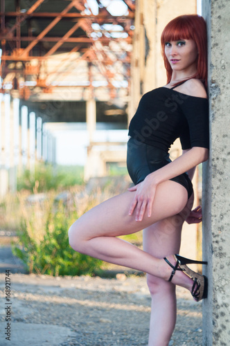 Red head sexy streaptease girl urban concrete destruct landscape photo