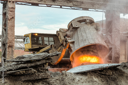 Unloading of hot slag by truck transporter to slag dump. Waste management metallurgical industry.