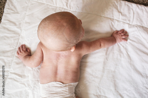 above a baby laying on a blanket