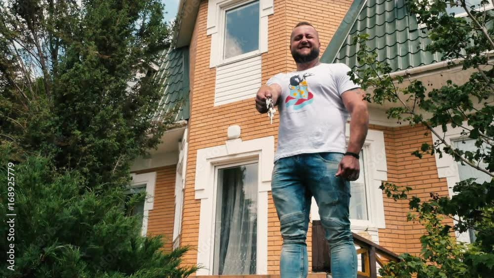 Happy new owner of the vacation home with keys Happy new owner of the vacation home with keys