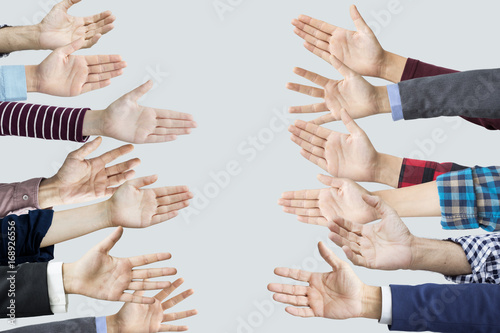 Many hands reaching sideways into  photo