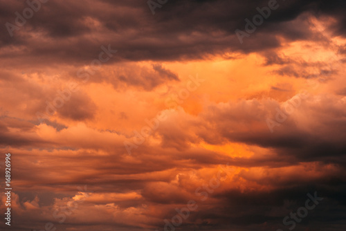 Clouds against the orange sky. Sky at sunset