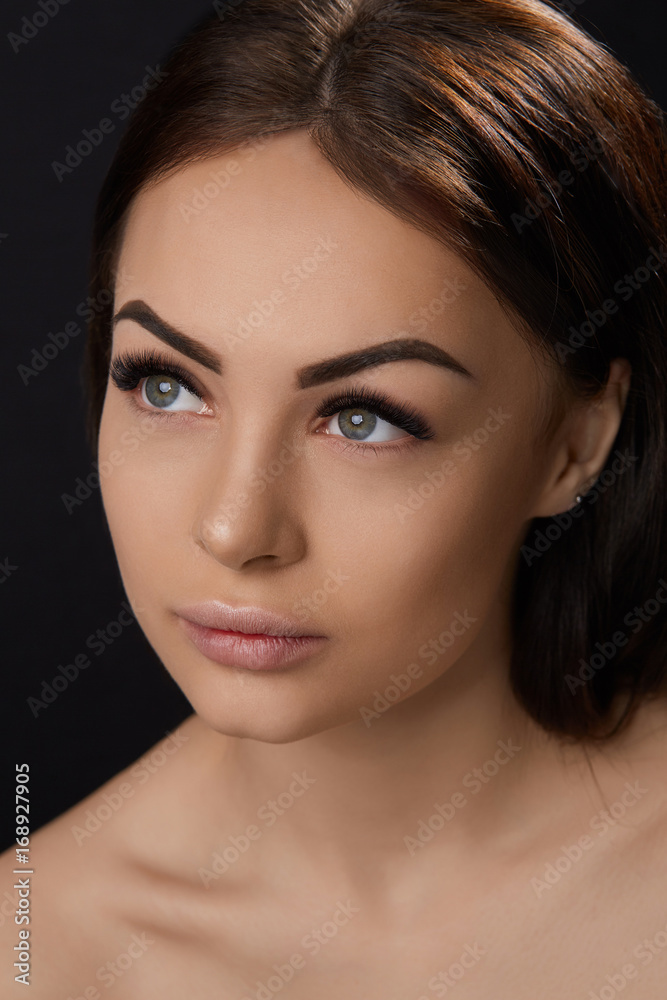Eyelashes extensions. Fake Eyelashes. Closeup Of Beautiful Young Female Model With Soft Smooth Skin And Professional Facial Makeup. Portrait Of Sexy Girl With Long Fake Eyelashes And Perfect Make-up. Eyelashes extensions. Fake Eyelashes. Closeup Of Beautiful Young Female Model With Soft Smooth Skin And Professional Facial Makeup. Portrait Of Sexy Girl With Long Fake Eyelashes And Perfect Make-up.