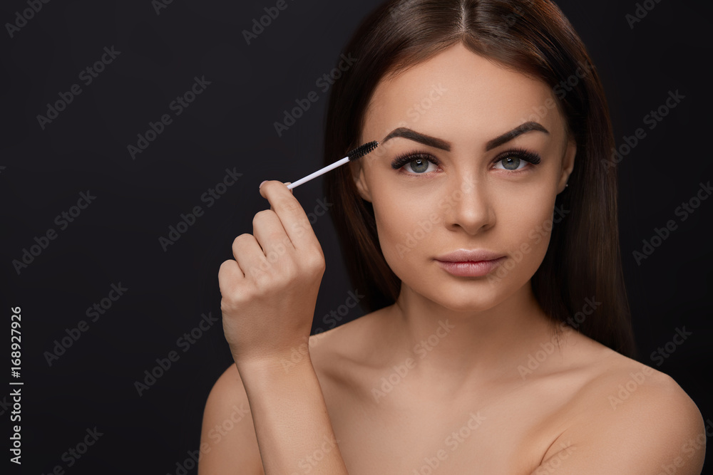 Mascara. Beauty Makeup, Fresh Soft Skin And Long Black Thick Eyelashes Applying Mascara With Cosmetic Brush. Eyelashes extensions. Fake Eyelashes.