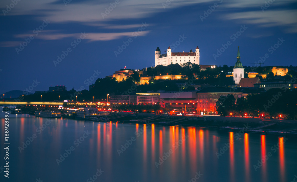 Castle of Bratislava, Slovakia at Night as Seen from a Bridge over Danube River Towards Old Town of Bratislava.