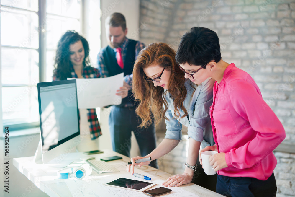 © NDABCREATIVITY - Group of young architects using digital tablet