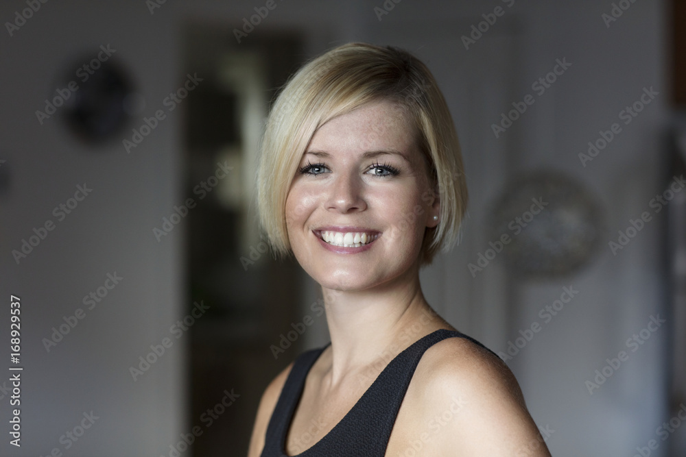 Close Up Of A Pretty Blond Woman Smiling At The Camera.