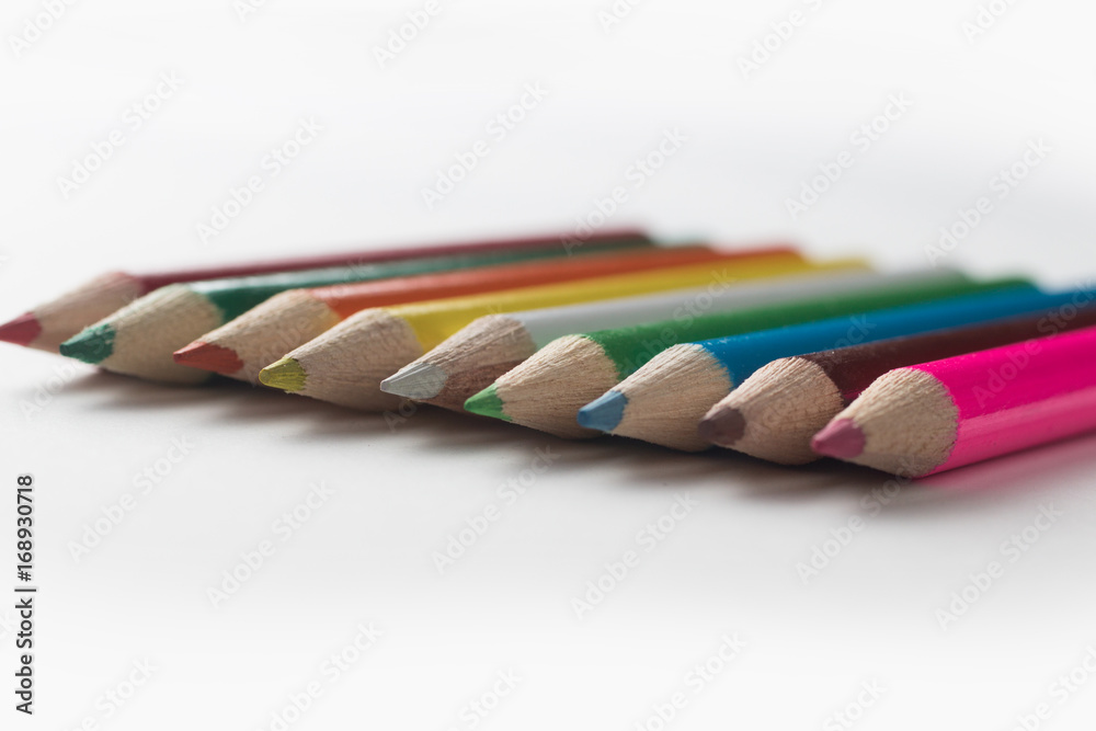Close-up of a group of multicolored pencils on a white backgroun Close-up of a group of multicolored pencils on a white backgroun