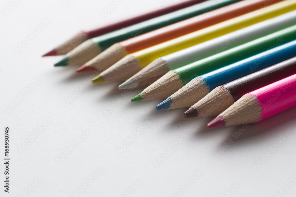 Close-up of a group of multicolored pencils on a white background Close-up of a group of multicolored pencils on a white background