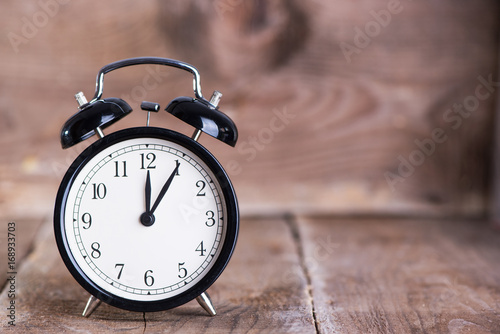 Alarm clock on wooden background 