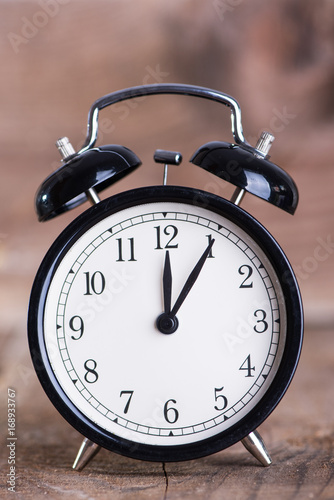 Alarm clock on wooden background 