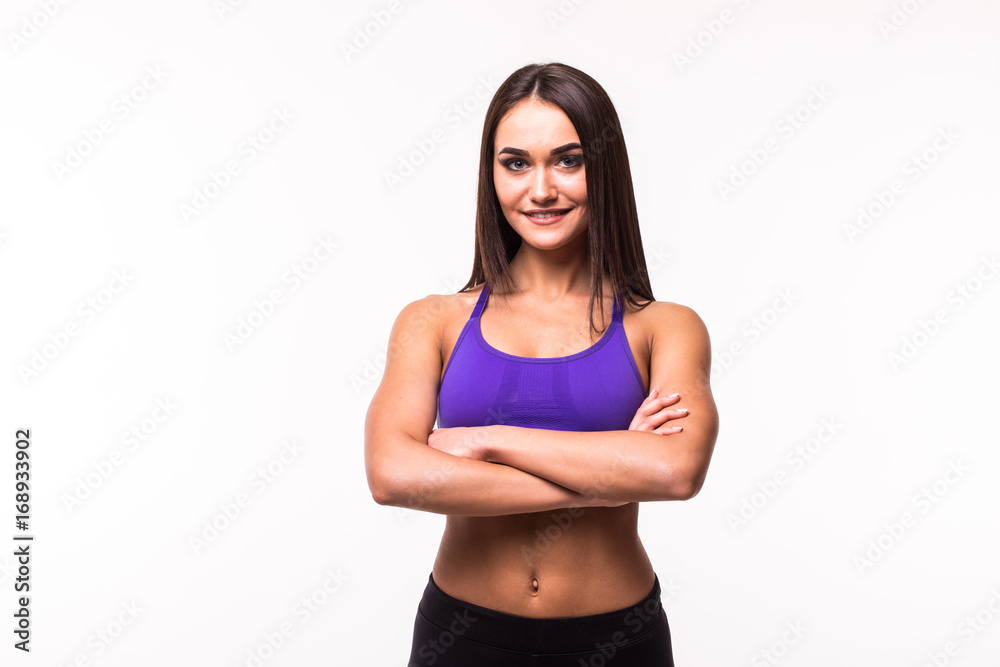 Smiling sports woman standing with arms folded and looking at camera isolated on a white background Smiling sports woman standing with arms folded and looking at camera isolated on a white background