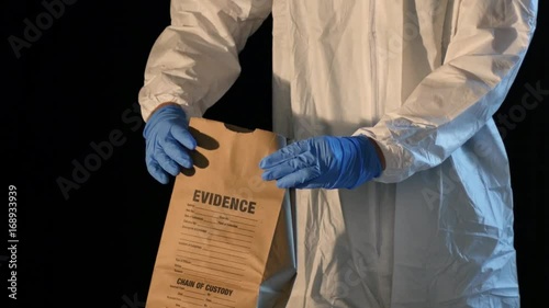 Crime scene forensic detective, weapon placed into evidence