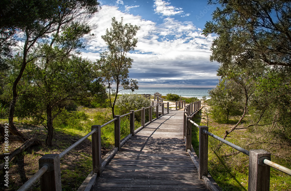 A wooden boardwalk leading to 7 Mile Beach near Gerroa in Australia