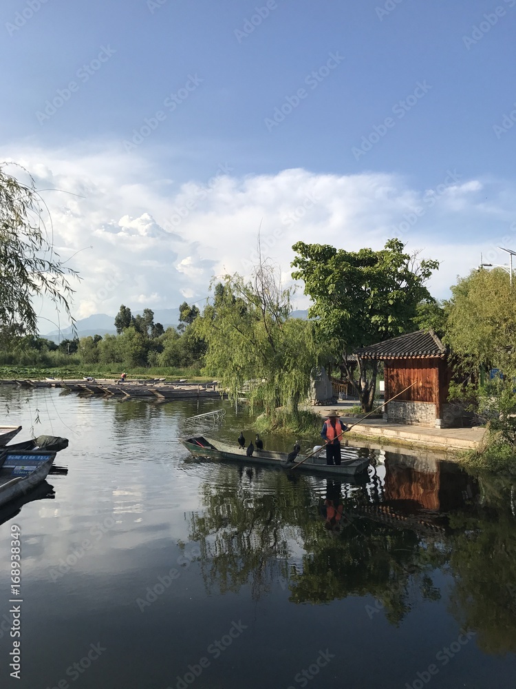 Bird catching fish for Chinese fisherman Bird catching fish for Chinese fisherman