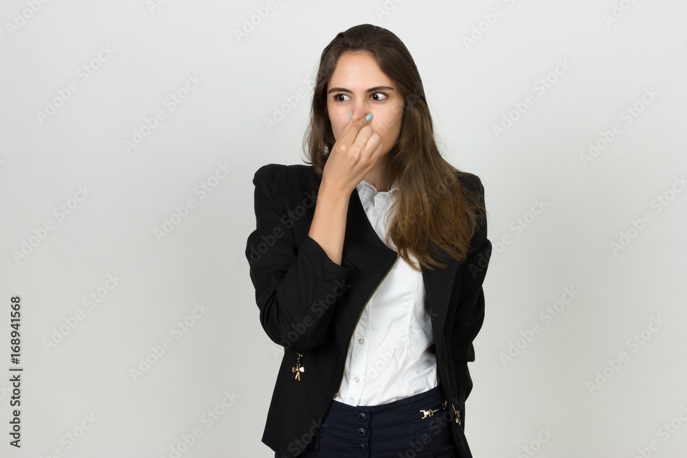 Young businesswoman holding her nose because of a bad smell Young businesswoman holding her nose because of a bad smell